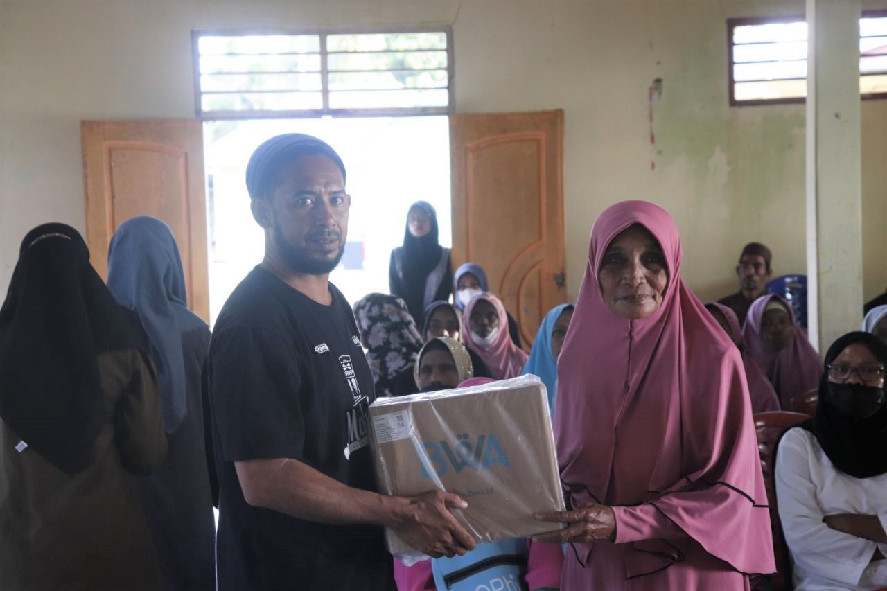 Ketua-Pemuda-Hijrah-Kei-Salim-Bugis-menyerahkan-Al-Quran-kepada-Ibu-ibu-Majelis-Talim-Pengelola-TPQ.