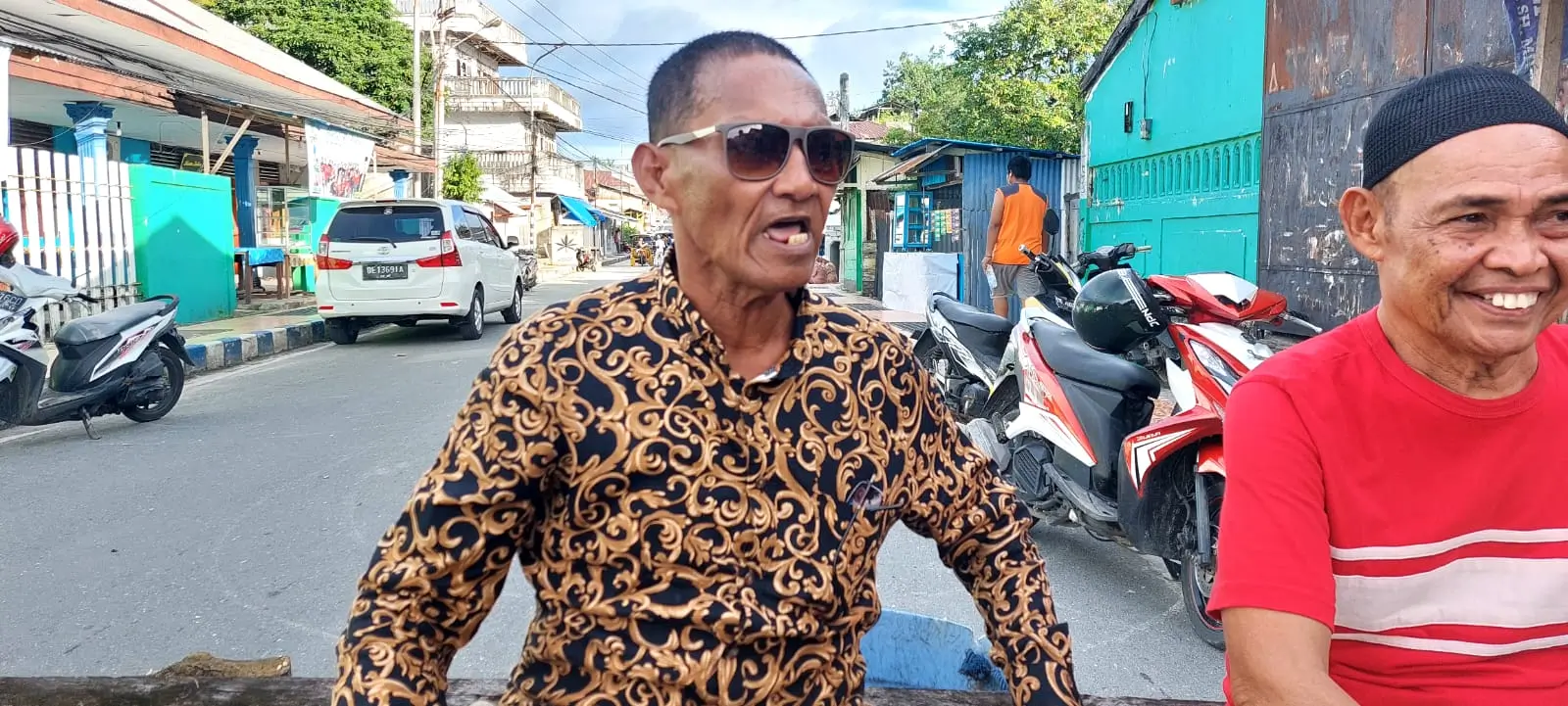 orang tua korban penembakan BNN, Salahudin Kabalmay duduk ditengah jalan utama yang diblokade senin sore